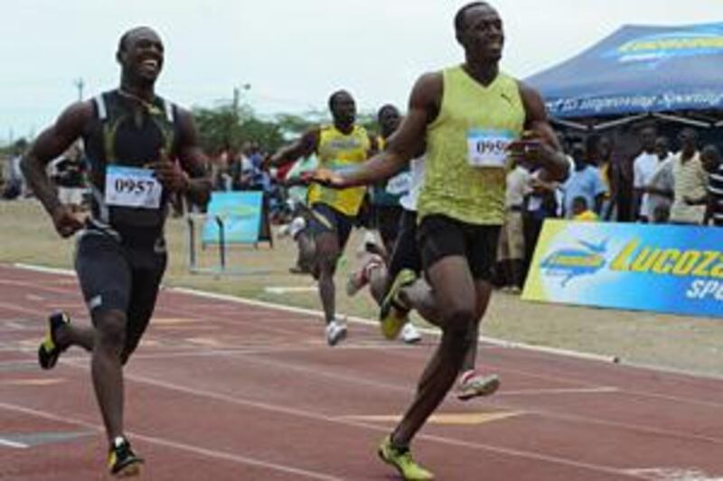 Usain Bolt, right, wins his first 100 metre race of 2009 during the GC Foster College Classic in Spanish Town, Jamaica on Saturday.