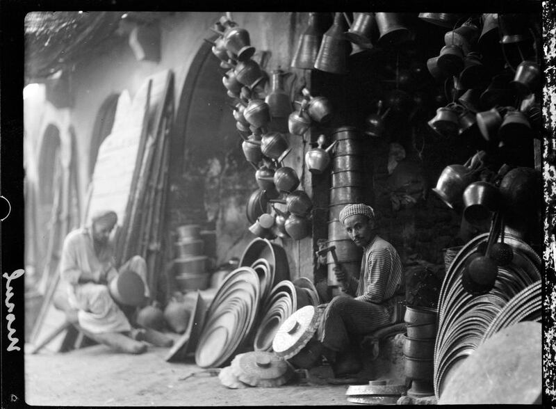 1932: A coppersmith working in the market in Mosul. AP Photo