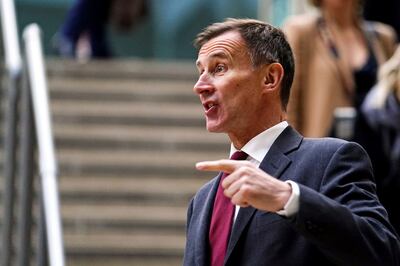 British Chancellor Jeremy Hunt said the UK economy was not 'out of the woods yet' after figures showed it avoided recession. AP