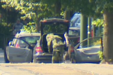 A bomb disposal expert searching the car of the alleged bomber team after it was stopped in Brussels. Reuters TV