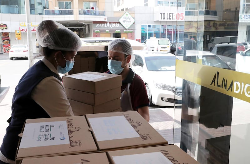 DUBAI, UNITED ARAB EMIRATES , May 01 – 2020 :- Staff of Al Nadeg restaurant loading the food packets to deliver at the labour camp in Al Muhaisnah area in Dubai. This is a part of Mohammed Bin Rashid Al Maktoum 10 Million Meals Global Initiative. Volunteers from Beit Al Khair Society will distribute the food packets in the labour camps. Today they are delivering 1000 food packets from Al Nadeg restaurant. Total 12000 food packets will be deliver in different labour camps in Dubai. (Pawan Singh / The National) For News/Online/Instagram. Story by Anam