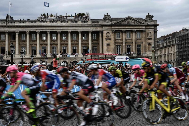 Fans cheer the pack of riders on the Place de la Concorde. AFP