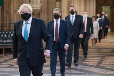 British Prime Minister Boris Johnson strides through Parliament ahead of opposition leaders on his way to listen to Queen Elizabeth II announce new legislation that will be implemented over the next year. Getty