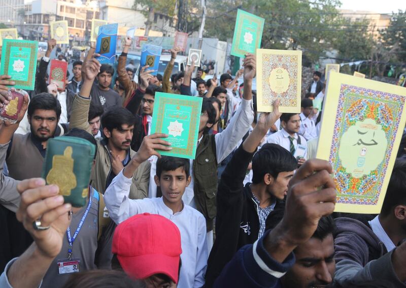 Pakistani protesters holding copies of the Muslims' holy book, the Quran, condemn a desecration of the Quran in the Norwegian city of Kristiansanda, in Lahore, Pakistan, Saturday, Nov. 23, 2019. Pakistan government conveyed its 'deep concern' to the ambassador of Norway on Saturday after a man desecrated the Holy Quran in the Norwegian city, official said. (AP Photo/K.M. Chaudary)