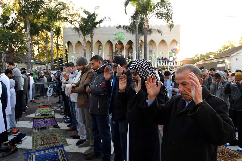Muslims offer prayers on the road outside the Lakemba mosque in Sydney, Australia.   Saeed Khan / AFP Photo