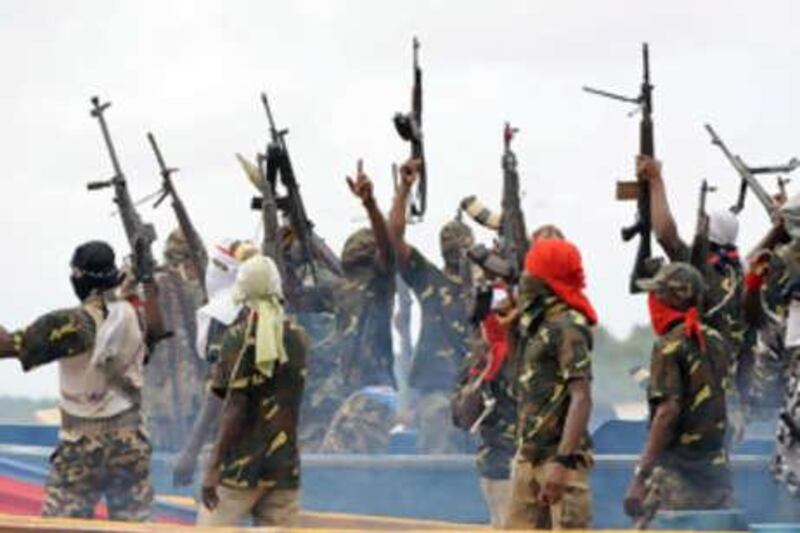 Fighters with the Movement for the Emancipation of the Niger Delta (MEND) raise their riffles to celebrate news of a successful operation by their colleagues against the Nigerian army in the Niger Delta.