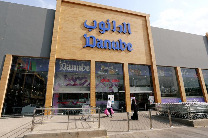 Customers wearing protective masks leave the Danube supermarket on Al-Takhassusi Street in Riyadh, Saudi Arabia. Reuters