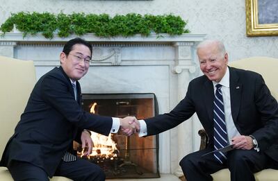 US President Joe Biden shakes hands with Japan's Prime Minister Fumio Kishida in the Oval Office. AFP