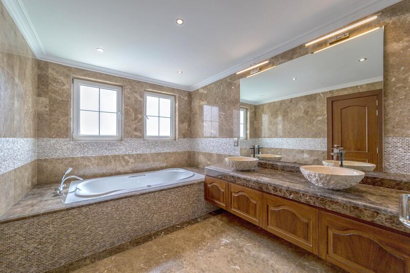 <p>The classic villa comes with marble and wood finishing in the bathroom. Courtesy LuxuryProperty.com</p>
