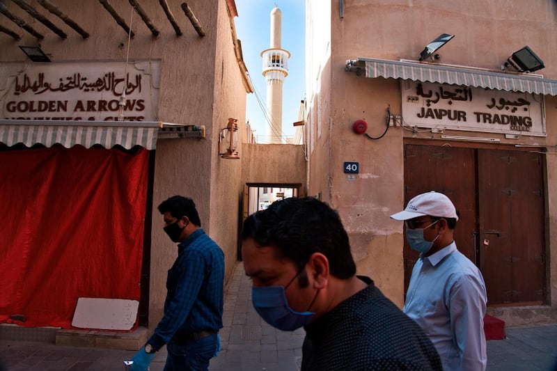 Pedestrians walk through a traditional Dubai souq where many shops had closed temporarily due to Covid-19, early in the pandemic. AP Photo