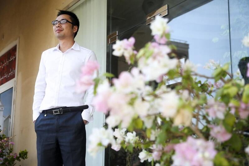 Sales agent Hai Rong Xiao of Atomic Properties in International City is kept busy with inquiries from Chinese investors, some of whom fly in with cash to snap up apartments in the city. Lee Hoagland / The National