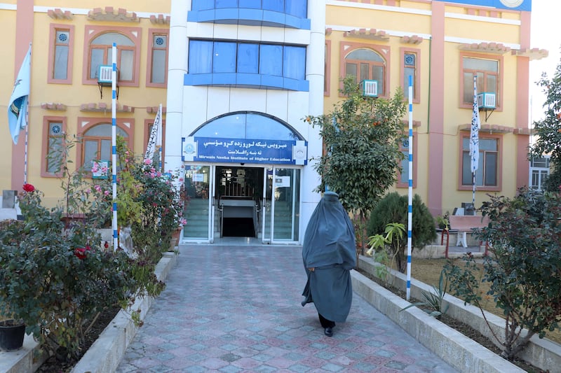 An Afghan female student leaves the Mirwais Neeka Institute of Higher Education in Kandahar. EPA