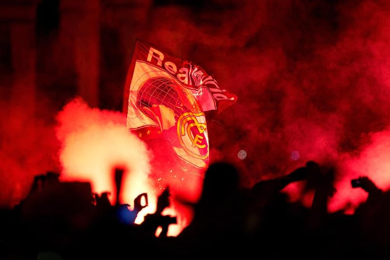 Real Madrid fans light a flare waiting to celebrate at Cibeles Square after the Champions League final on Saturday. Gonzalo Arroyo Moreno / Getty Images / May 24, 2014