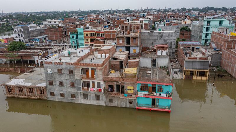 Floodwater surrounds houses on the banks of the Ganges after heavy monsoon rain in Prayagraj, India. AP