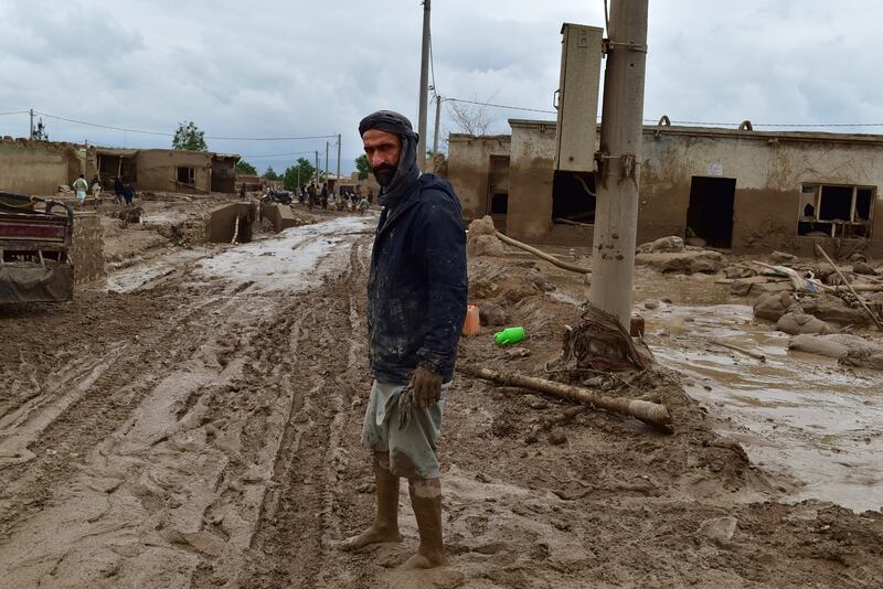 An Afghan man stands near his flood-damaged home. The victims, mainly women and children, were killed when flash floods hit five districts of Baghlan province. AP