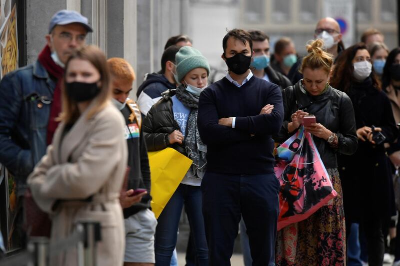 Shoppers queue to enter an Apple store after new nationwide restrictions were announced during the coronavirus disease (COVID-19) outbreak in London, Britain, November 2, 2020. REUTERS/Toby Melville