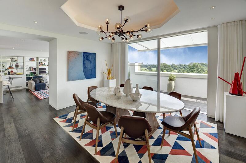 The dining area with views out to Hyde Park. Courtesy Berkshire Hathaway HomeServices London