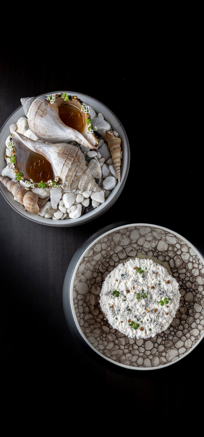 A welk shell served on a bed of sand and filled with umami dashi at Ossiano. Photo: Atlantis, The Palm