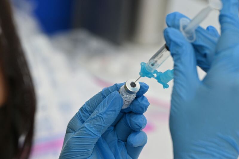 A healthcare worker fills a syringe with Pfizer Covid-19 vaccine at a community vaccination event in Los Angeles, California, on August 11, 2021. AFP