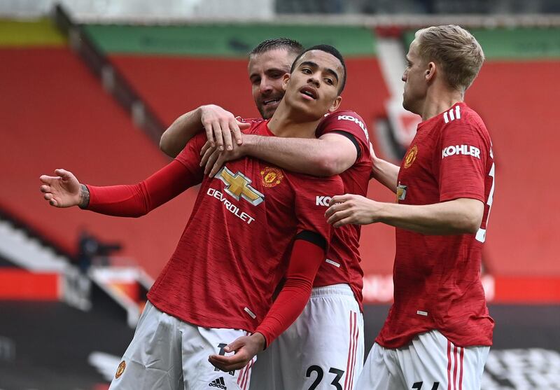 Manchester United's Mason Greenwood celebrates with Luke Shaw and Donny van de Beek after scoring their second goal in a 3-1 Premier League win over Burnley on Sunday, April 18. Reuters