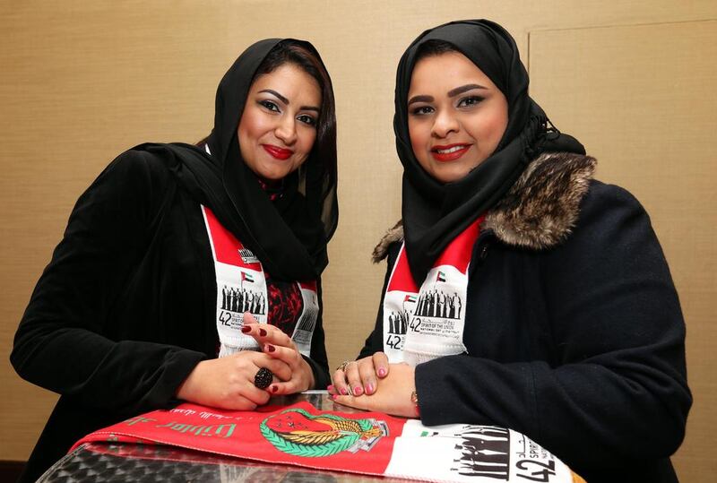 Emirati students Fatima Al Dhaheri, left, and Mona bin Hussain at the National Day party in London. Stephen Lock for The National