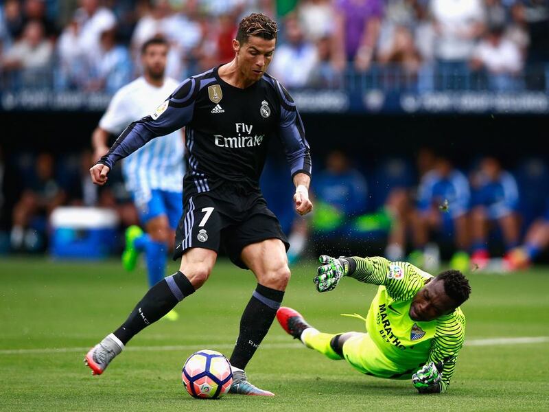 Cristiano Ronaldo of Real Madrid scores his sides first goal against Malaga at La Rosaleda Stadium on May 21, 2017 in Malaga, Spain. Gonzalo Arroyo Moreno / Getty Images