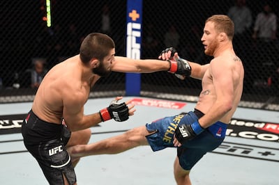 ABU DHABI, UNITED ARAB EMIRATES - OCTOBER 25:  (R-L) Justin Gaethje kicks Khabib Nurmagomedov of Russia in their lightweight title bout during the UFC 254 event on October 25, 2020 on UFC Fight Island, Abu Dhabi, United Arab Emirates. (Photo by Josh Hedges/Zuffa LLC via Getty Images)