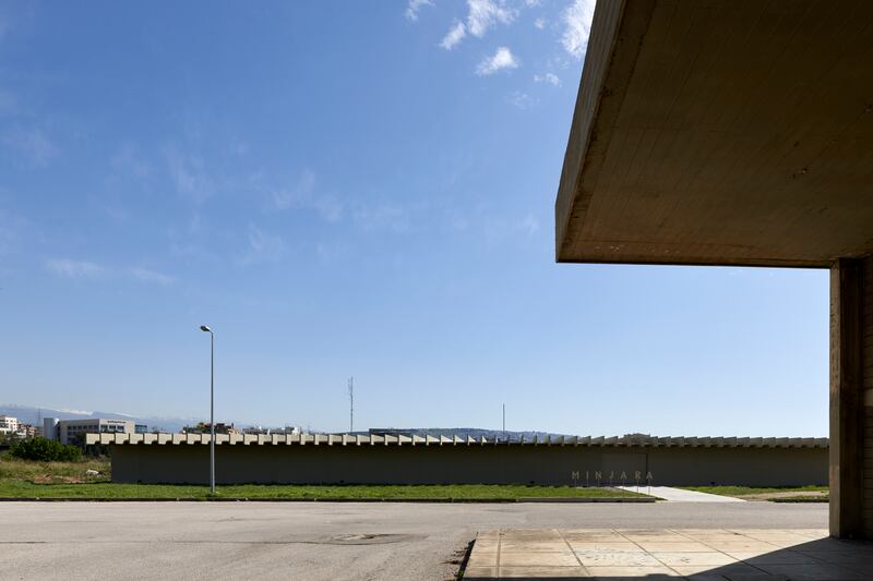 The horizontal concrete structure with a windowless facade.