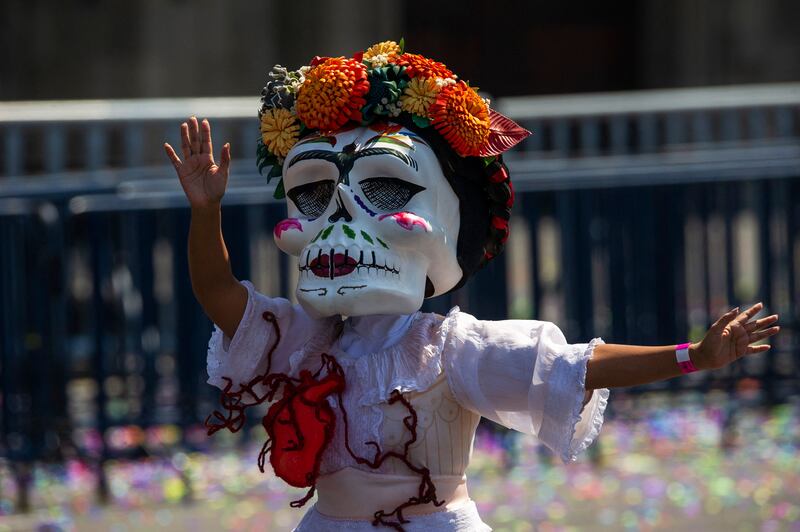 A woman with a Catrina mask attends the Day of the Dead parade at Zocalo Square in Mexico City. AFP