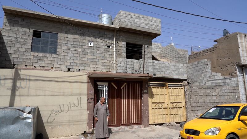 Bassam Mohammed Hashim outside his house in Mosul that he rebuilt himself. Mahmoud Rida/ The National