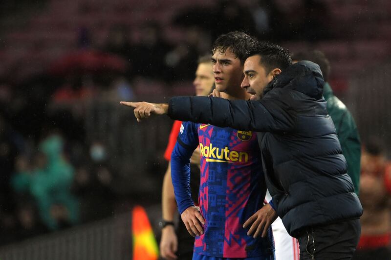 Barcelona's Spanish coach Xavi gives instructions to midfielder Gavi. AFP