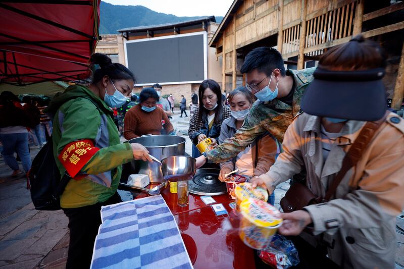 Relief supplies are distributed to residents in Moxi, a town in Luding county, after the quake. AP