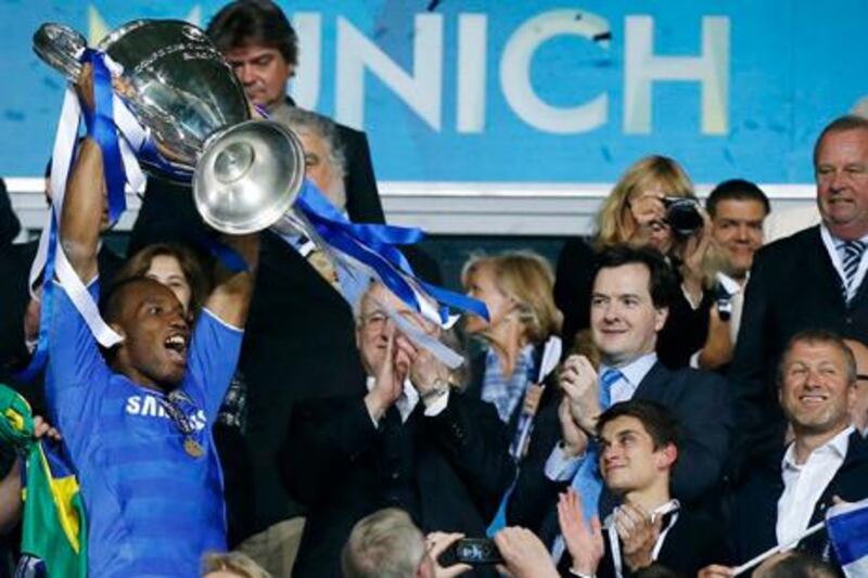 Chelsea's Didier Drogba holds up the trophy at the end of the Champions League final soccer match between Bayern Munich and Chelsea in Munich, Germany Saturday May 19, 2012. Didier Drogba scored the decisive penalty in the shootout as Chelsea beat Bayern Munich to win the Champions League final after a dramatic 1-1 draw on Saturday. (AP Photo/Matt Dunham)