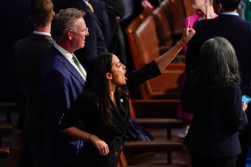 Representative Alexandria Ocasio-Cortez gestures to the Clerk of the House that there is one more Democratic vote to be cast during the roll call vote on the motion to adjourn. AP