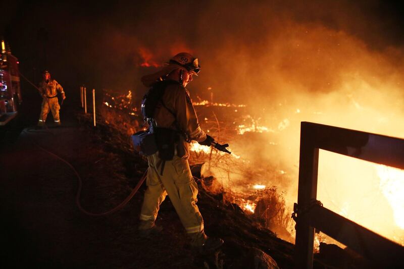 Firefighters walk to the fire line.  Sandy Huffaker / AFP Photo