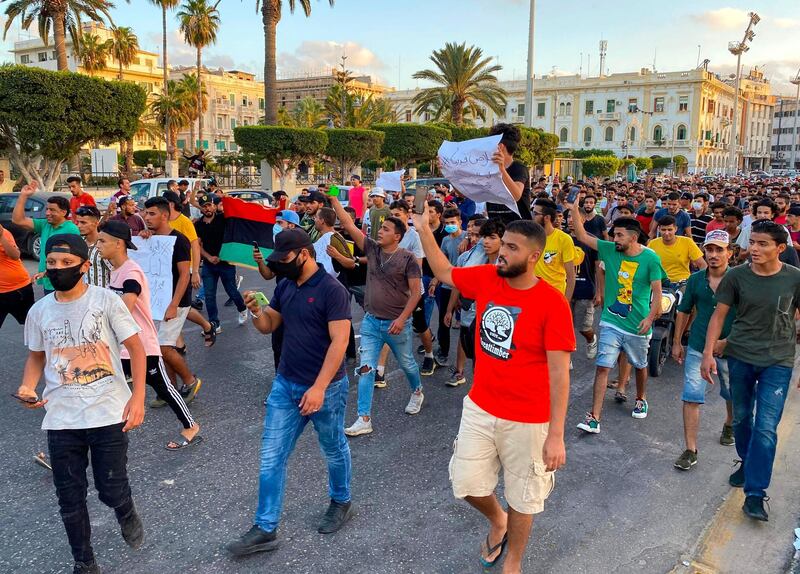 Libyans chant slogans during a demonstration due to poor public services at the Martyrs' Square at the centre of the GNA-held Libyan capital Tripoli. AFP