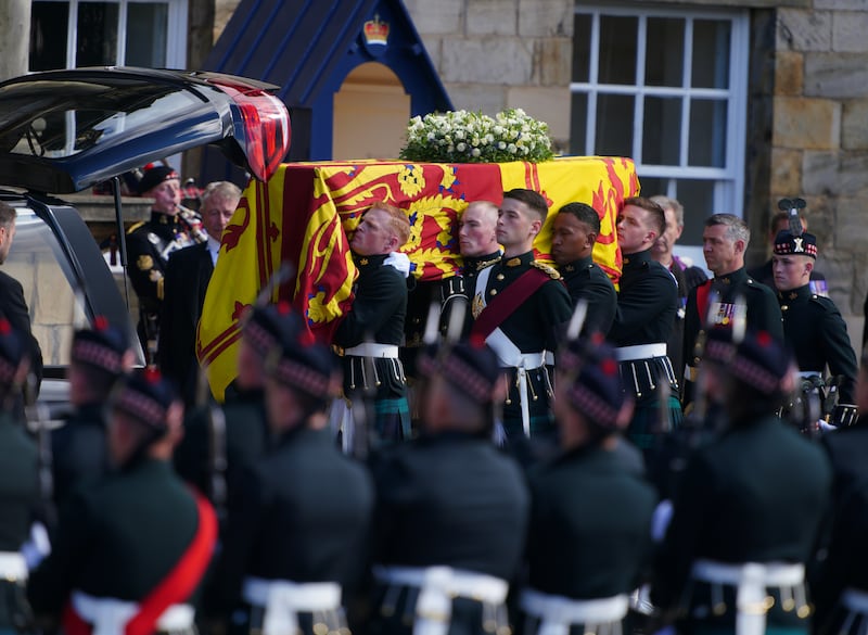 Royal guards carry Queen Elizabeth's coffin at the start of the procession. PA