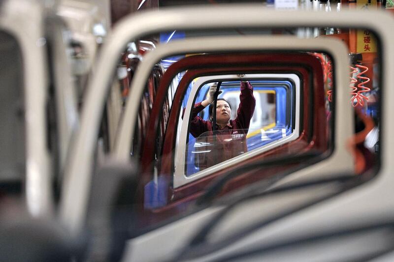 A worker installs rubber onto the windows of the doors along a production line at a truck factory of Anhui Jianghuai Automobile in Anhui province. Activity in China’s manufacturing sector contracted for a fourth consecutive month in April, the HSBC/Markit flash Purchasing Managers Index showed, adding to questions about whether the world’s second-largest economy is still losing momentum. Reuters