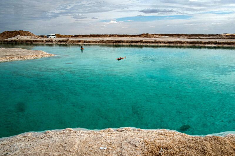 People wade in the Siwa salt lake in Egypt's western desert oasis of Siwa, about 55 kilometres east of the Libyan border and about 750 kilometres west of the capital. AFP