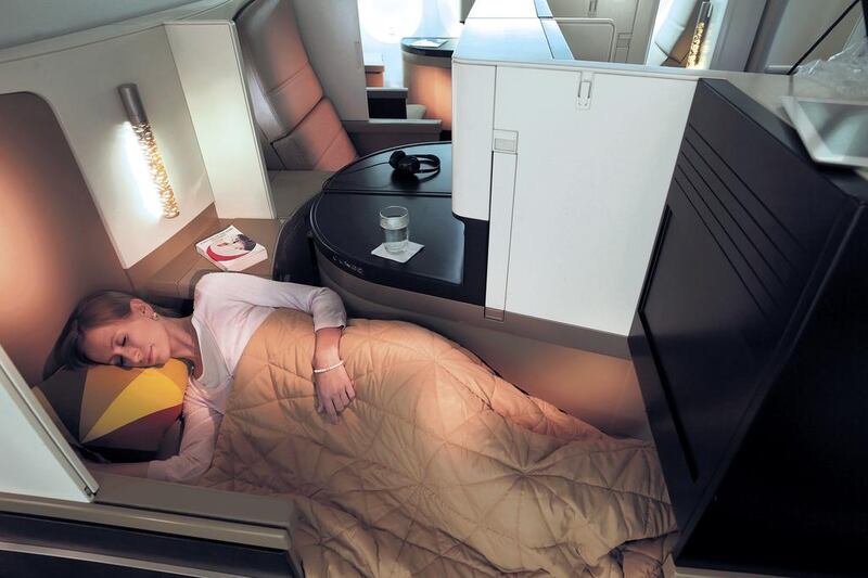 Etihad’s A380 business class seating has room to lie down and get some sleep. Courtesy Etihad