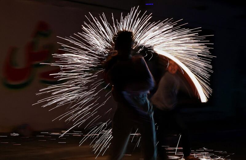 Palestinian children play with sparklers in the street after iftar in Gaza City. AFP