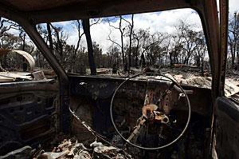 A burnt out vehicle amongst the devastation at a property after an overnight fire roared through the Lloyds Hill subdivision area near Toodyay, about 85km north-east of Perth in Western Australia.