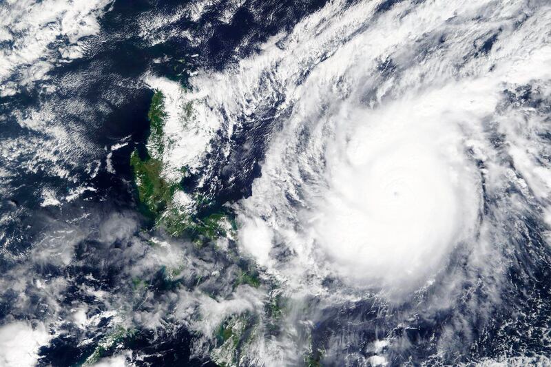 Satellite image released by NASA Worldview, Earth Observing System Data and Information System (EOSDIS) shows a typhoon locally known as Goni moving around the Philippines. NASA via AP