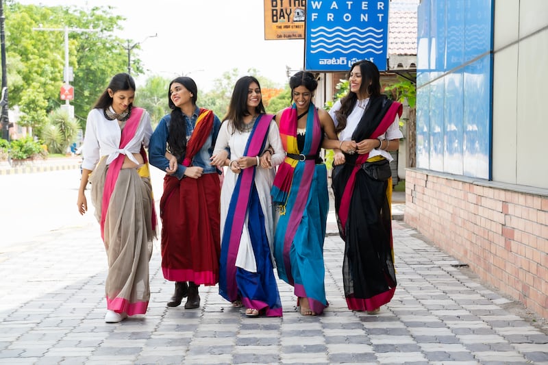 Young Indian women are draping and styling saris in myriad ways, from pairing them with T-shirts and trainers to holding the pallu, or loose end of the sari, in place with a belt. Photo: Six Yards Plus