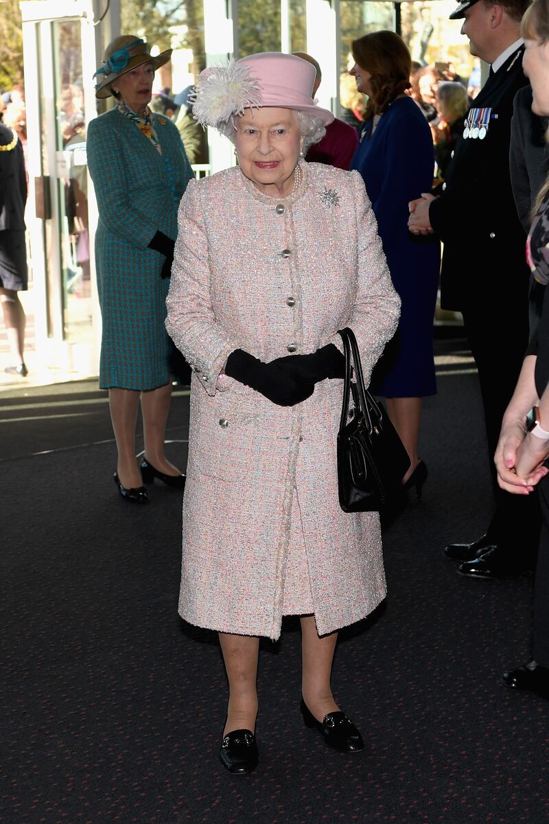 Queen Elizabeth II, wearing light pink, arrives to the Chichester Theatre while visiting West Sussex, England, on November 30, 2017. Getty Images