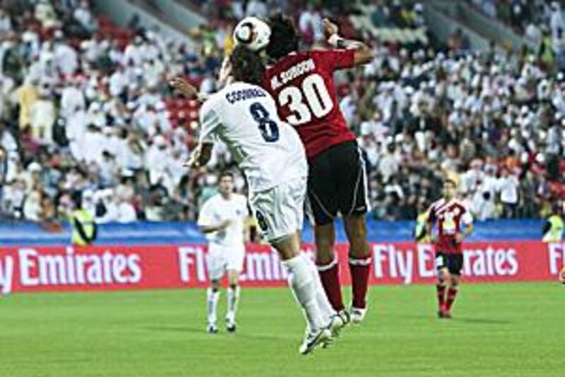 Chad Coombes, left, scorer of Auckland City's second goal, competes for the ball in the air with Al Ahli's Mohammed Suroor.