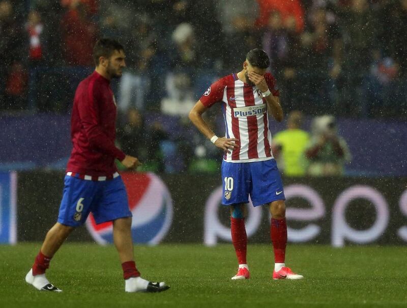 Atletico’s Yannick Carrasco, right, looks dejected at the end of the match. Daniel Ochoa de Olza / AP Photo
