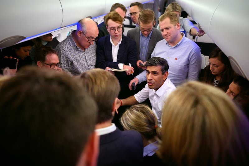 British Prime Minister Rishi Sunak holds a 'huddle' press conference with political journalists on board a plane heading for Bali. PA