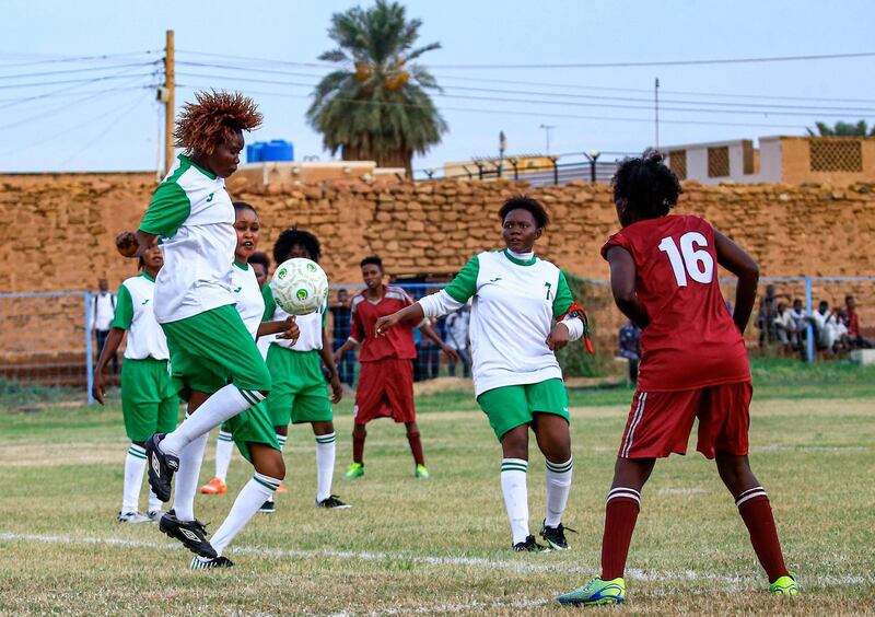 Sudanese women's football league clubs Abbasiya and Karnak vie for the ball during their match at the Dar al-Riyadah stadium in the city of Omdurman. AFP