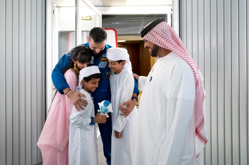 Dr Al Neyadi greets his father Saif Al Neyadi and his children during the homecoming reception. Photo: UAE Presidential Court